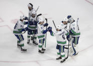Vancouver Canucks celebrate the team's win over the Vegas Golden Knights during Game 2 of an NHL hockey second-round playoff series, Tuesday, Aug. 25, 2020, in Edmonton, Alberta. (Jason Franson/The Canadian Press via AP)