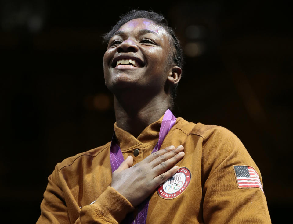 Gold medalist Claressa Shields of the United participates in the medals ceremony after their women's final middleweight 75-kg gold medal boxing match at the 2012 Summer Olympics, Thursday, Aug. 9, 2012, in London. (AP Photo/Ivan Sekretarev)