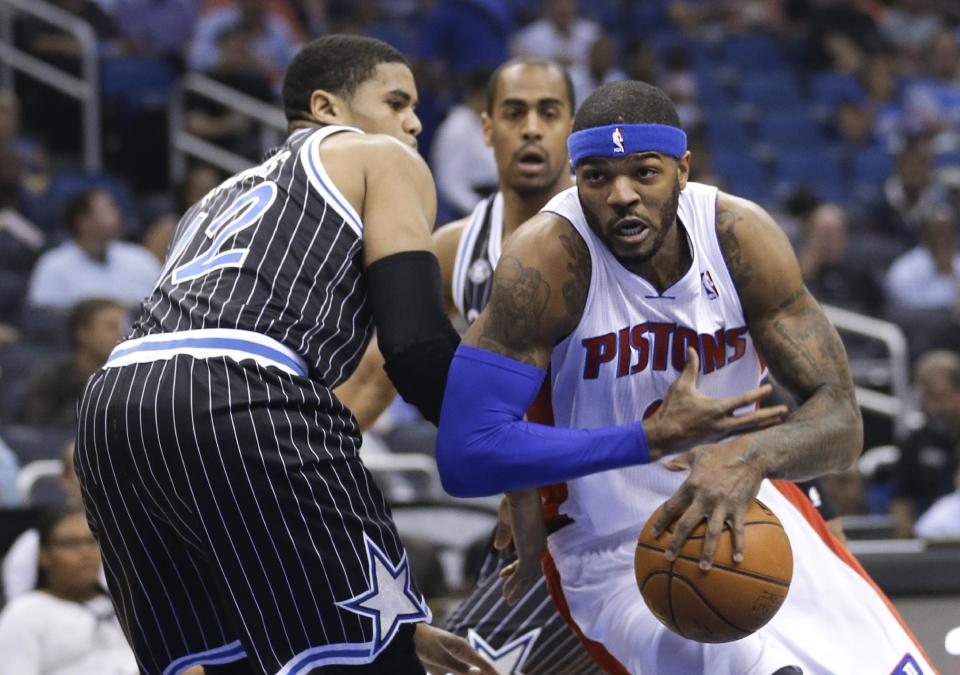 Detroit Pistons' Josh Smith, right, drives to the basket past Orlando Magic's Tobias Harris during the first half of an NBA basketball game in Orlando, Fla., Wednesday, Feb. 5, 2014. (AP Photo/John Raoux)