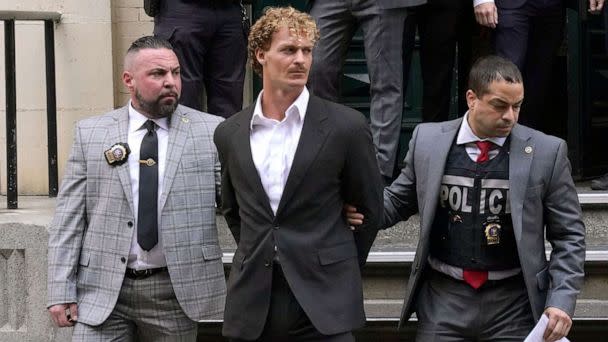 PHOTO: Daniel Penny, center, is walked out of the New York Police Department 5th Precinct in Lower Manhattan, May 12, 2023, after he surrendered to authorities after being charged with 2nd Degree Manslaughter in the chokehold death of Jordan Neely. (Timothy A. Clary/AFP via Getty Images)