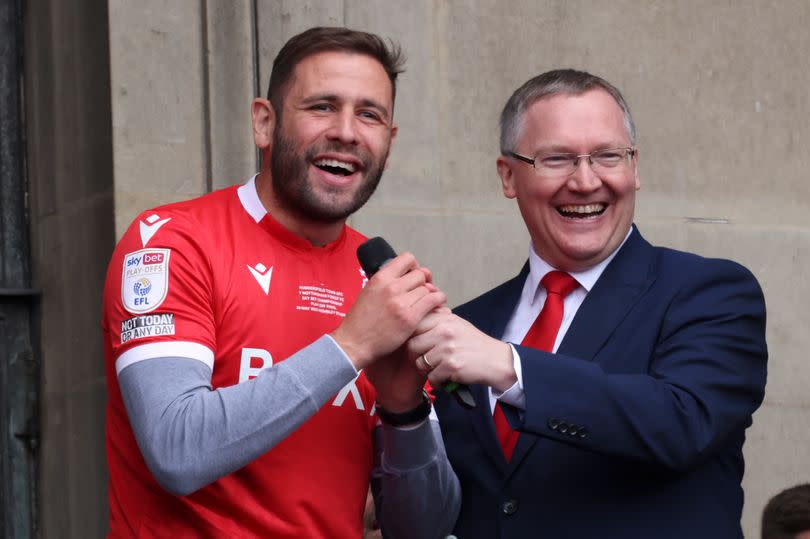 Nottingham Forest's Steve Cook pictured alongside BBC Radio Nottingham's Colin Fray on the balcony of the Council House in Nottingham's Old Market Square, during a celebration event following Nottingham Forest's promotion to the Premier League. -Credit:Joseph Raynor/ Nottingham Post