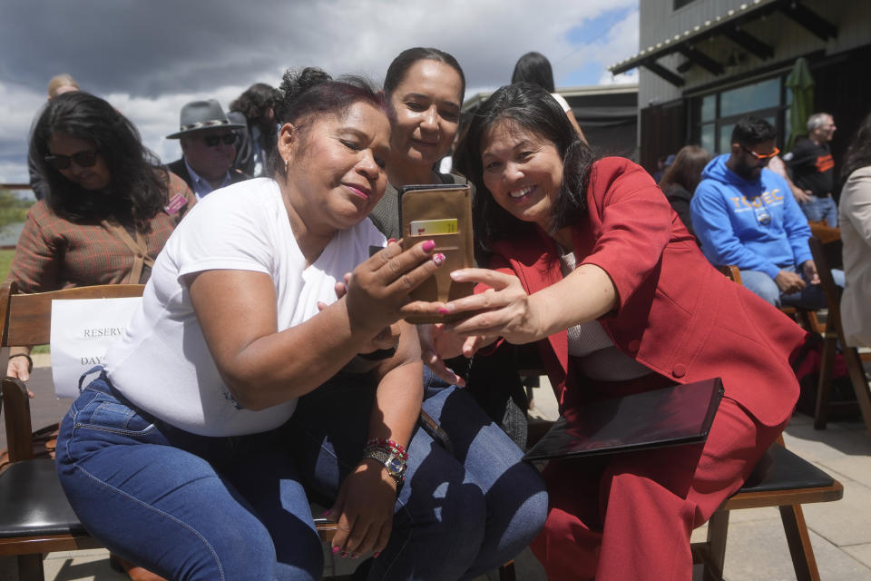 Acting United States Secretary of Labor Julie Su, right, poses for photos with farmworkers Daysi Estrada Fuentes, left, and Maria Castillas at a news conference at Balletto Vineyards in Santa Rosa, Calif., Friday, April 26, 2024. Temporary farmworkers workers are getting more legal protections against employer retaliation, unsafe working conditions, illegal recruitment and other abuses. The rule announced Friday by the Biden administration aims to bolster support workers on H-2A visas. (AP Photo/Jeff Chiu)