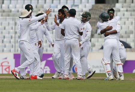 Cricket - Bangladesh v England - Second Test cricket match - Sher-e-Bangla Stadium, Dhaka, Bangladesh - 29/10/16. Bangladesh's Mehedi Hasan Miraz (4th L) is congratulated by his teammates after taking the wicket of England's Zafar Ansari. REUTERS/Mohammad Ponir Hossain