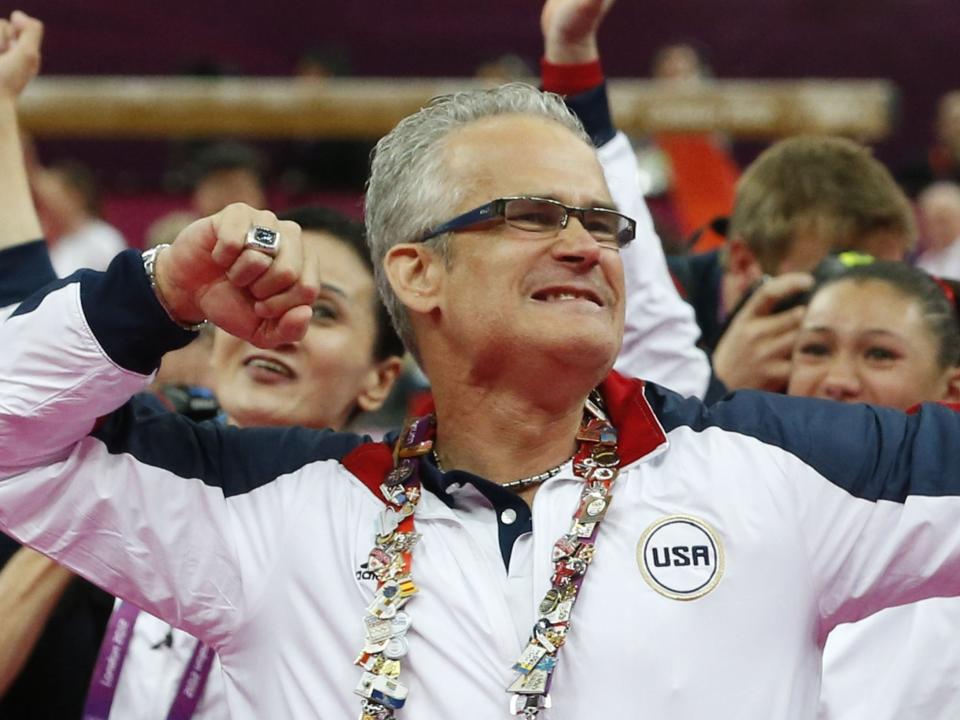 <p>El entrenador del equipo de gimnasia femenina estadounidense John Geddert celebra con el equipo después de que Estados Unidos ganara el oro en el equipo femenino del evento de gimnasia artística de los Juegos Olímpicos de Londres el 31 de julio de 2012 en el 02 North Greenwich Arena de Londres. El equipo de Estados Unidos ganó el oro, el equipo de Rusia se llevó la plata y el equipo de Rumania obtuvo el bronce. </p> (AFP PHOTO / THOMAS COEX / AFP PHOTO / AFP a través de Getty Images)