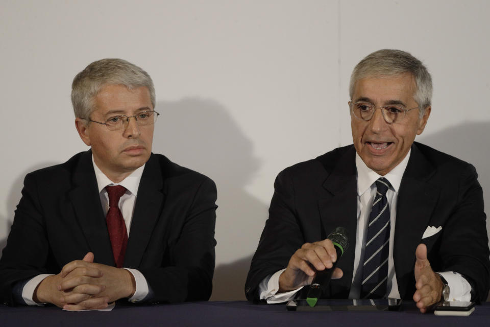 Carabinieri General Giuseppe Spina, right, flanked by Albania's Interior Minister Sander Lleshaj, talks during a press conference at Rome's Fiumicino airport Friday, Nov. 8, 2019. 11-year-old Alvin, an Albanian boy who was taken to Syria by his mother when she joined the Islamic State group has been freed from a crowded detention camp in northeastern Syria and returned home to Italy where his father lives. (AP Photo/Gregorio Borgia)