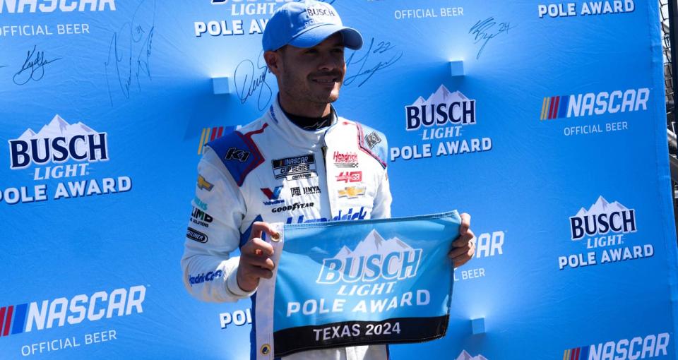 Kyle Larson poses for a photo following his NASCAR Cup Series pole victory at Texas Motor Speedway.