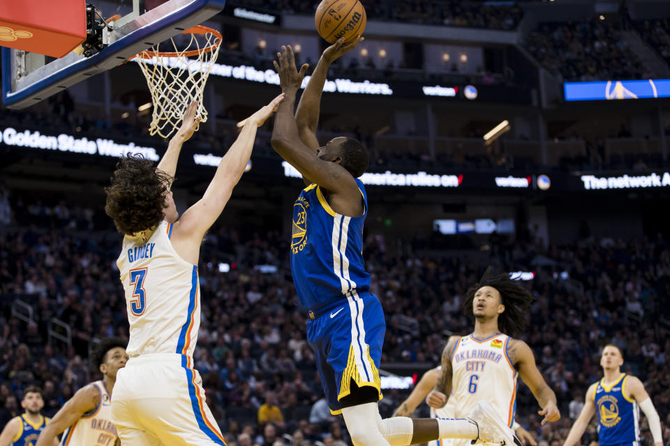 Oklahoma City Thunder guard Josh Giddey (3) defends against Golden State Warriors forward Draymond Green (23) during the first half of an NBA basketball game in San Francisco, Monday, Feb. 6, 2023. (AP Photo/John Hefti)