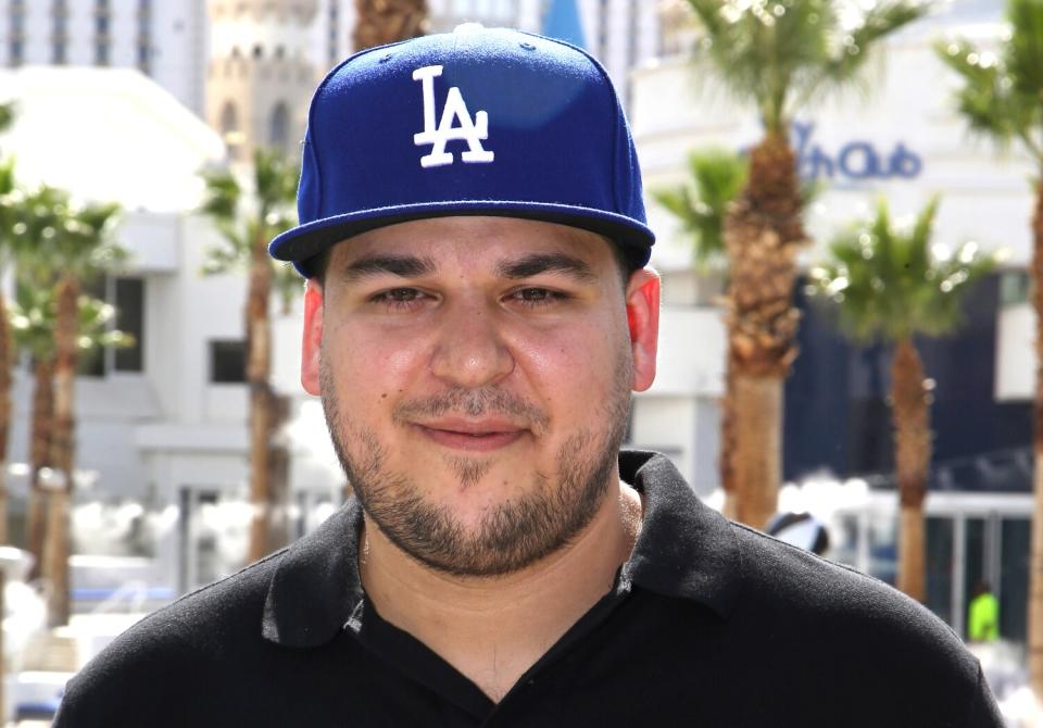 A man in a blue baseball cap and black polo shirt