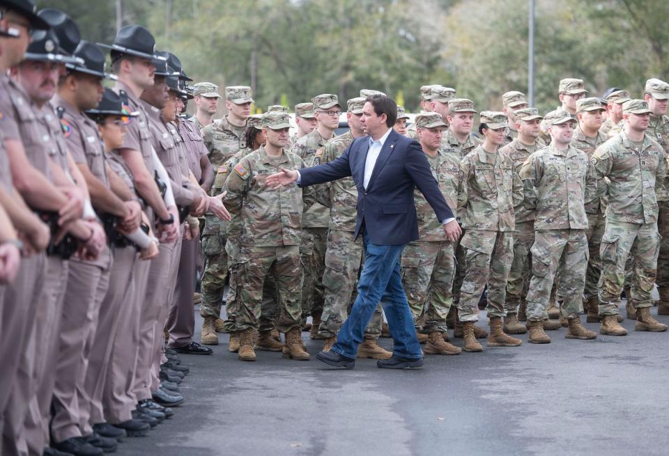 Florida Governor Ron DeSantis greets Florida State Troopers and National Guard members during a press conference in Pensacola on February 23, 2024.