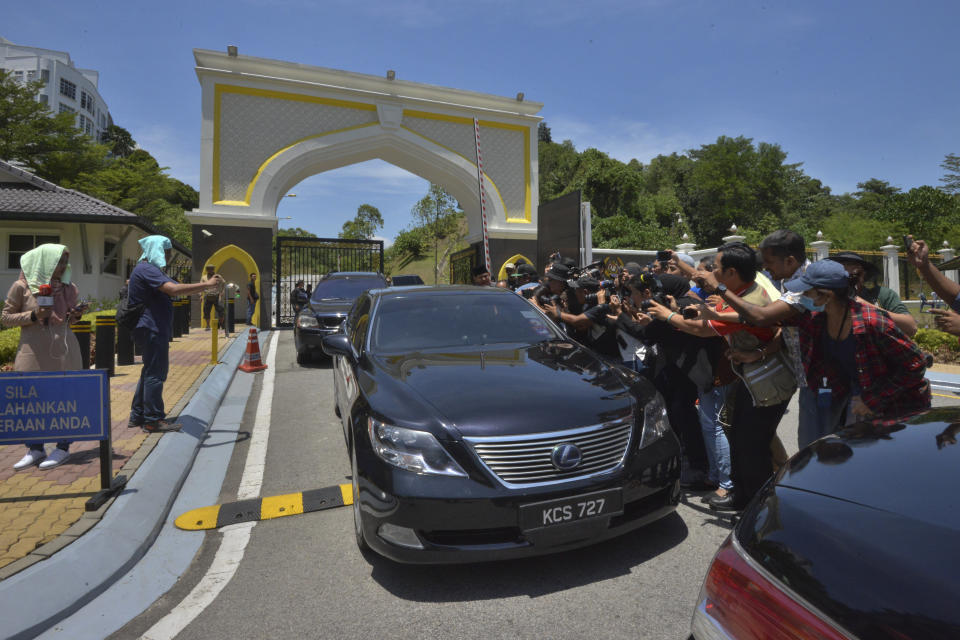 Journalists try to film Anwar Ibrahim inside the car entering the palace to meet the king in Kuala Lumpur, Saturday, Feb. 29, 2020. Malaysian leader Mahathir Mohamad indicated Saturday that he will reconcile with the former ruling alliance he led with rival Anwar Ibrahim in an about-turn that follows a week of political turmoil that followed his resignation as prime minister. (AP Photo)