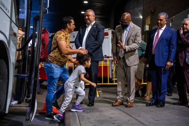 From left to right: Manuel Castro, commissioner of the New York City Mayor's Office of Immigrant Affairs; Gary Jenkins, commissioner of the New York City Department of Social Services; and Rep. Adriano Espaillat (D) greet asylum seekers as they arrive at the Port Authority Bus Terminal on Sept. 9, 2022.