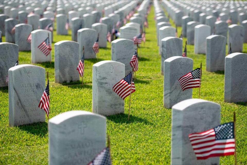 Thousands of tiny American flags decorate the graves of American service members at Biloxi National Cemetery in Biloxi ahead of Memorial Day on Saturday, May 25, 2024.