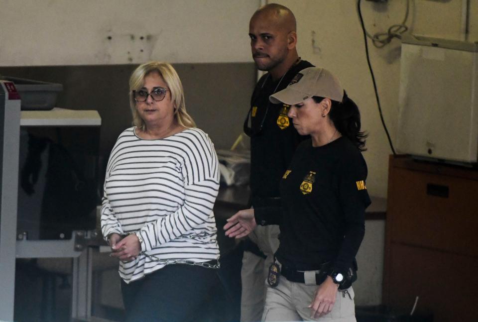 Federal agents escort former Puerto Rico Health Insurance Administration head Ángela Ávila-Marrero who was arrested in San Juan, Puerto Rico, July 10, 2019.