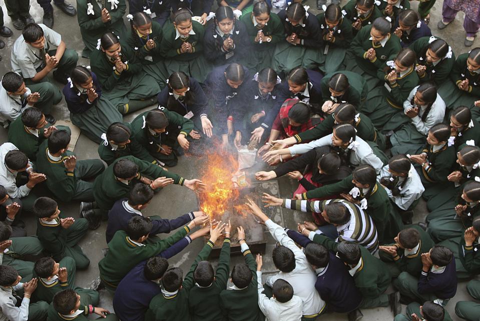 Students attend a prayer ceremony in tribute to passengers and crew onboard missing Malaysia Airlines flight MH370, inside a school in Jammu