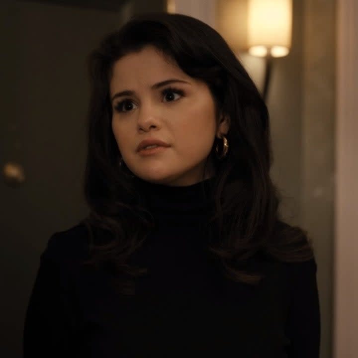 Photo of Selena Gomez as Mabel in a black turtleneck and gold earrings