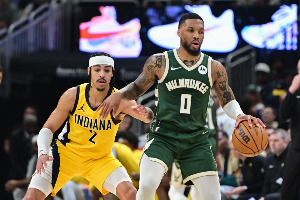 The Milwaukee Bucks' Damian Lillard (0) drives for the basket against the Indiana Pacers.