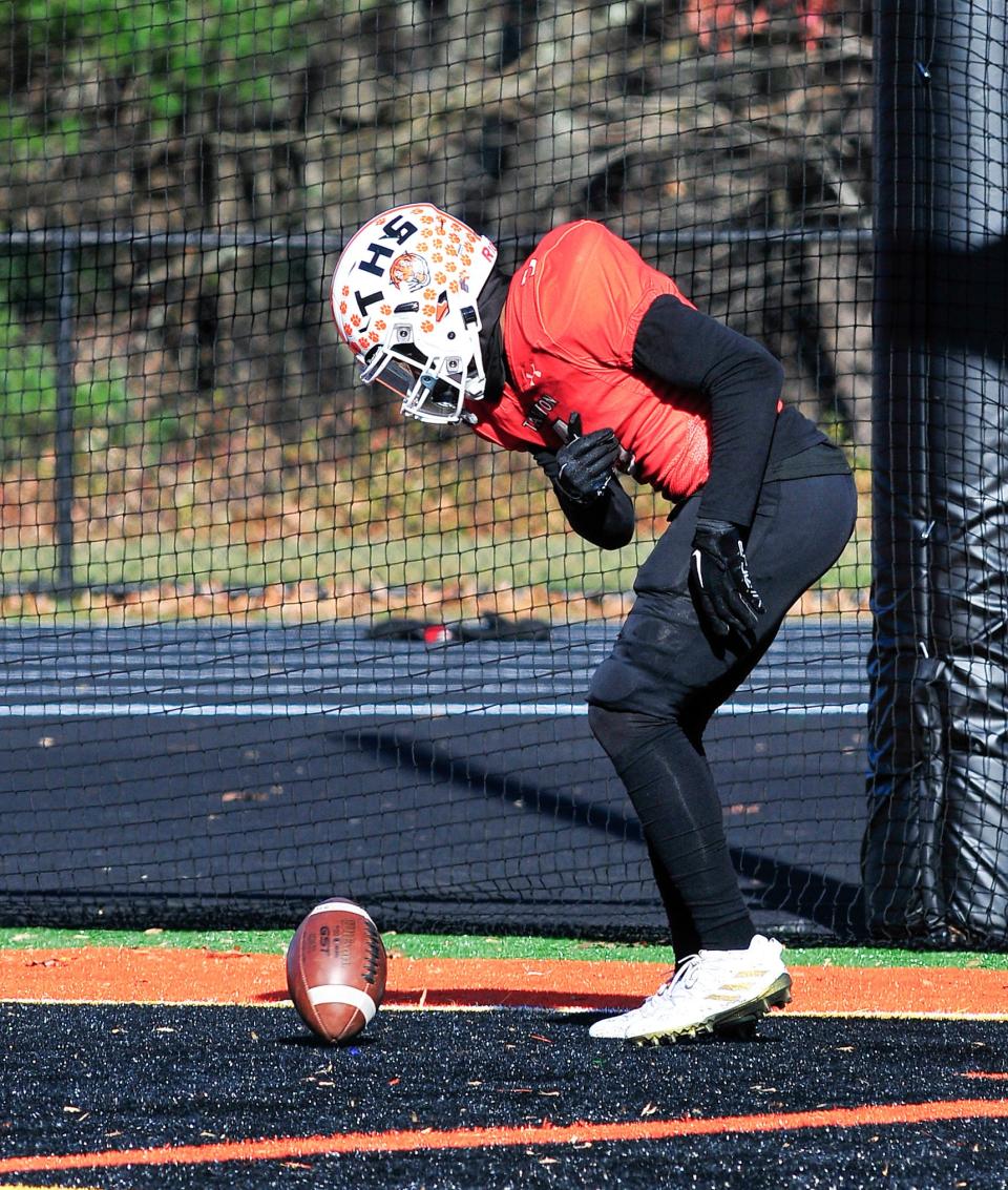 Taunton’s Dmitrius Shearrion celebrates a touchdown catch by spinning the football during Thursday’s Thanksgiving Day game against Milford.