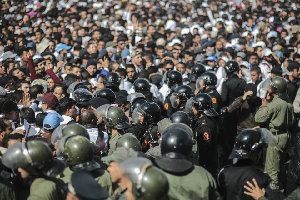 Security forces stand guard as they attempt to disperse a protest by teachers in Rabat, Morocco, Wednesday, Feb. 20, 2019. Moroccan police fired water cannons at protesting teachers who were marching toward a royal palace and beat people with truncheons amid demonstrations around the capital Wednesday. (AP Photo/Mosa'ab Elshamy)