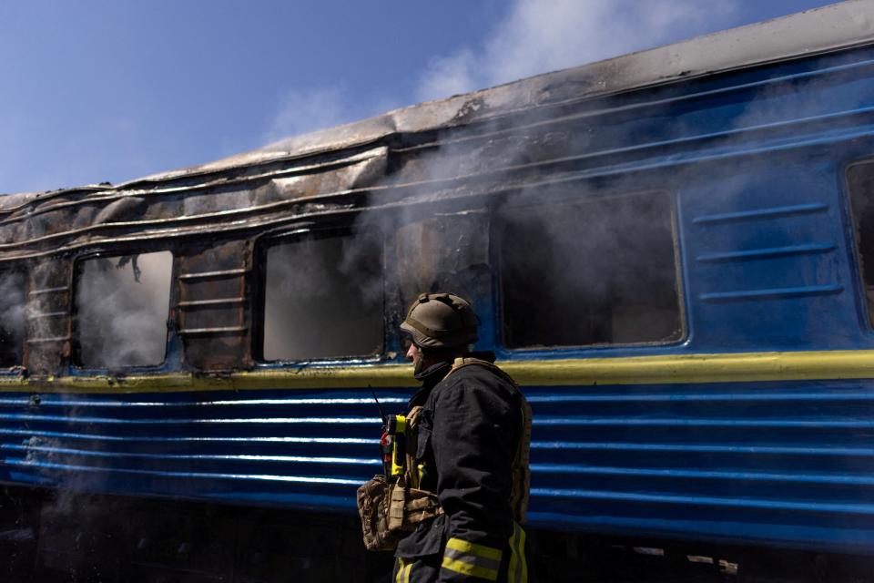 A firefighter works at a Kherson train station hit by a Russian military strike (Reuters)