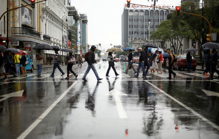 People walk on the main street of the city of San Jose, which looks empty as Hurricane Otto approaches in San Jose, Costa Rica November 24, 2016. REUTERS/ Juan Carlos Ulate