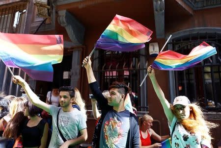 LGBT rights activists wave rainbow flags during a transgender pride parade which was banned by the governorship, in central Istanbul, Turkey, June 19, 2016. REUTERS/Osman Orsal