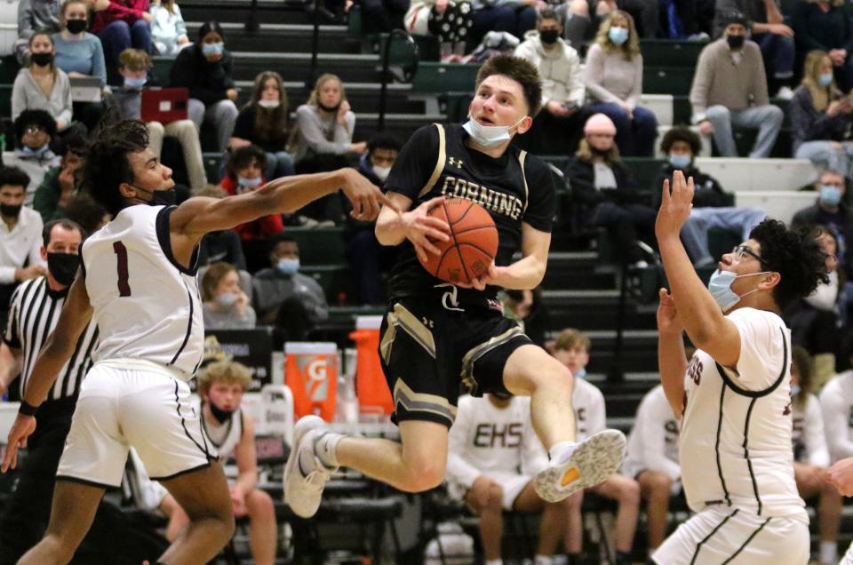 Corning's Jackson Casey is defended by Elmira's Anthony Brooks (1) and Chris Woodard during the Express' 47-32 win in boys basketball Feb. 9, 2022 at Elmira High School.