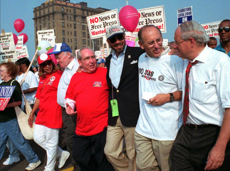 Detroit Mayor Dennis Archer, center, leads the annual Detroit Labor Day parade with United Auto Workers union president Stephen Yokich, second from right, and Senator Carl Levin, right, on Woodward Ave. on Sept. 2, 1996, in Detroit.