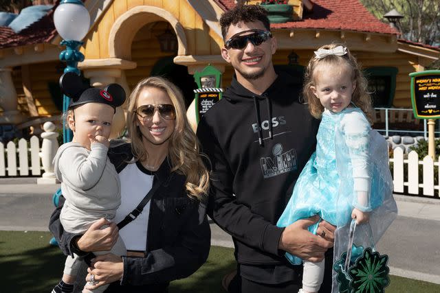 <p>Sean Teegarden/Disneyland Resort</p> MVP Patrick Mahomes of the Kansas City Chiefs poses with his wife, Brittany Mahomes, their children Sterling, 2, and Bronze 1