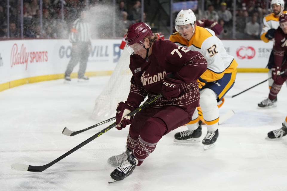 Arizona Coyotes center Travis Boyd (72) skates away from Nashville Predators defenseman Cal Foote in the first period during an NHL hockey game, Thursday, March 9, 2023, in Tempe, Ariz. (AP Photo/Rick Scuteri)