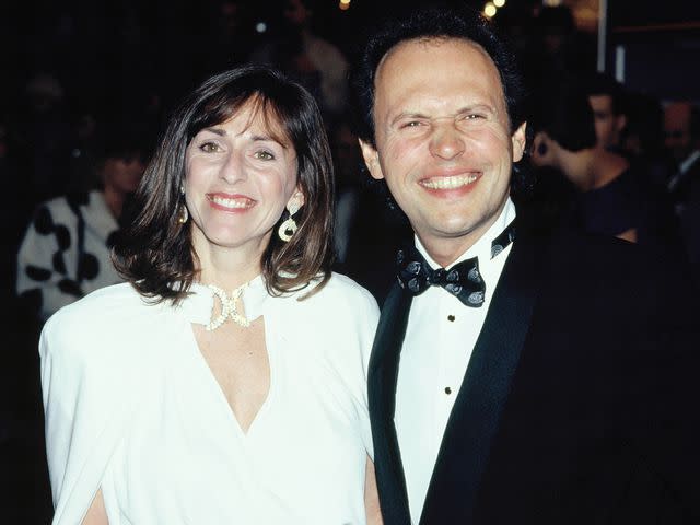 <p>Georges De Keerle/Getty</p> Billy Crystal and Janice Crystal smiling in 1988