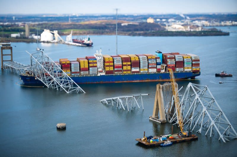 A Coast Guard Air Station Elizabeth City MH-60 Jayhawk crew conducts an overflight assessment of the Francis Scott Key Bridge collapse in Baltimore on March 29. On Monday, a fourth body was recovered in the collapse, as federal investigators began a criminal probe. Photo by PO1 Brandon Giles/U. S. Coast Guard