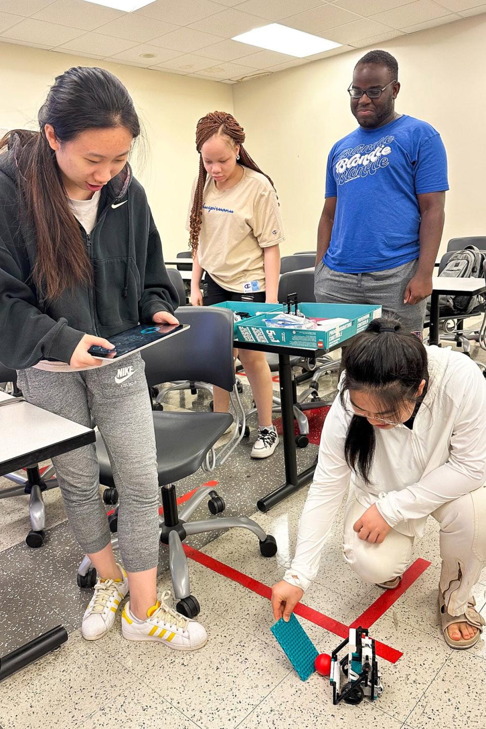 Middle Tennessee State University computer science students have fun with robots as part of a summer enrichment program to support female computer science students at the Kirksey Old Main Building on campus on June 29, 2023. Standing, from left, are Haiting Cai, Christabel Obi-Nwosu, Kosy Okafor, and Xingyu Chen.