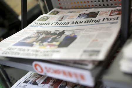 Copies of the South China Morning Post (SCMP) newspaper are seen on a newspaper stand in Hong Kong, China November 26, 2015. REUTERS/Tyrone Siu