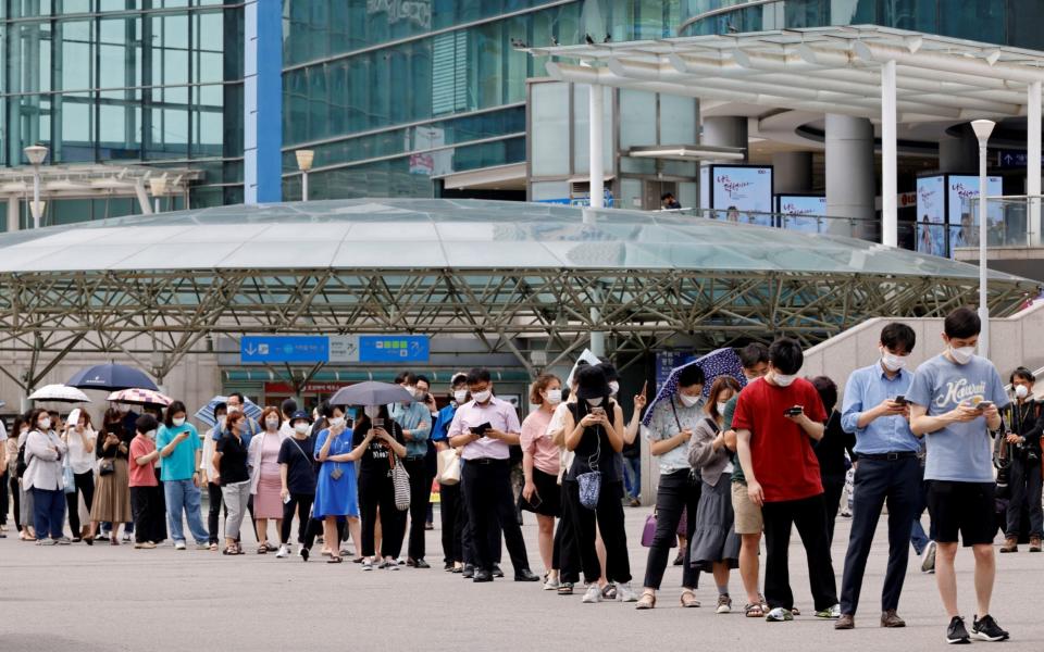 People wait in line for a coronavirus disease (COVID-19) test at a testing site, temporarily set up at a railway station in Seoul, South Korea, July 7, 2021. - Reuters