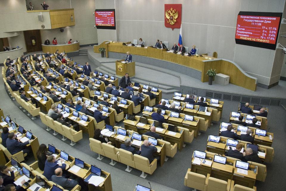 Russian lawmaker Olga Batalina, on a podium, addresses the State Duma (lower parliament house) in Moscow, Russia, Wednesday, Jan. 25, 2017. The State Duma voted overwhelmingly Wednesday to eliminate criminal liability for battery on family members that does not cause bodily harm. The bill that makes battery on a family member punishable by a fine or a 15-day day arrest has yet to be approved in the third reading. (AP Photo/Alexander Zemlianichenko)