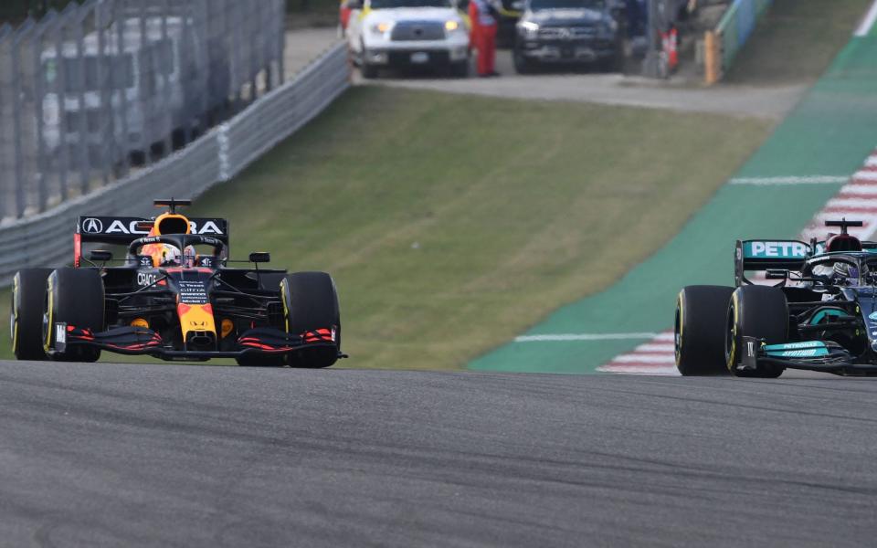 Red Bull's Dutch driver Max Verstappen (L) and Mercedes' British driver Lewis Hamilton race to the first turn during the second practice session at the Circuit of The Americas in Austin, Texas, on October 22, 2021, ahead of the United States Grand Prix - ROBYN BECK/AFP via Getty Images