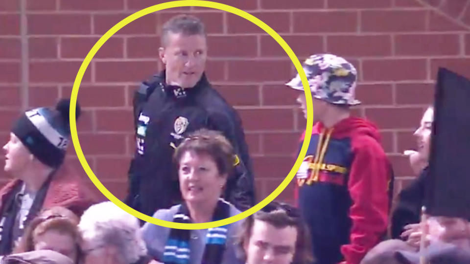 Richmond coach Damien Hardwick (pictured) turning back to respond to a fan.