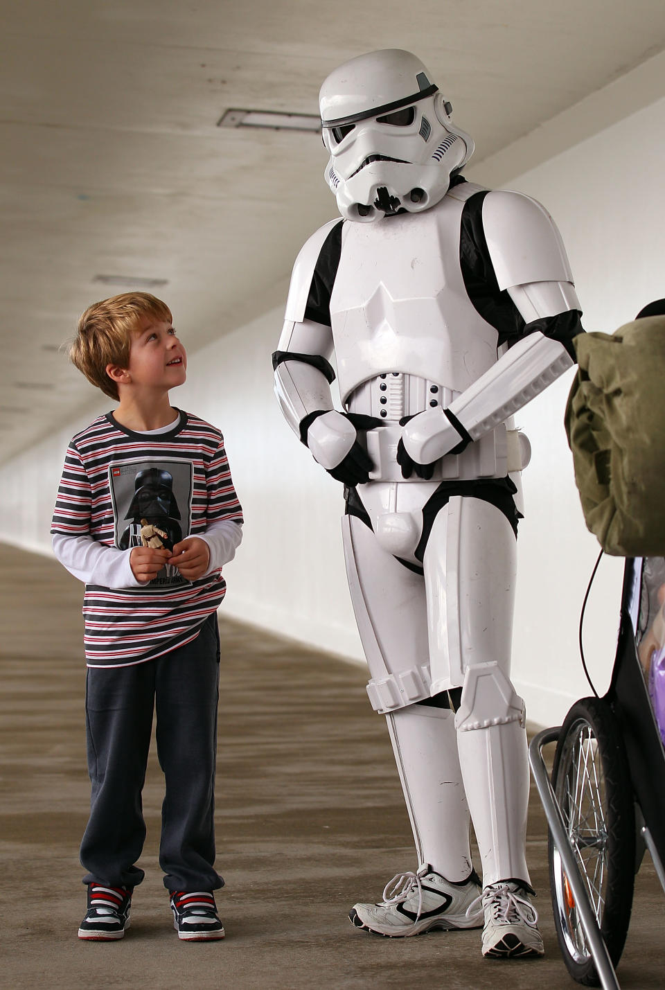 PERTH, AUSTRALIA - JULY 15: Stormtrooper Paul French is pictured on day 5 of his over 4,000 kilometre journey from Perth to Sydney talking with a young Star Wars fan at Port Bouvard bridge on July 15, 2011 in Perth, Australia. French aims to walk 35-40 kilometres a day, 5 days a week, in full Stormtrooper costume until he reaches Sydney. French is walking to raise money for the Starlight Foundation - an organisation that aims to brighten the lives of ill and hostpitalised children in Australia. (Photo by Paul Kane/Getty Images)