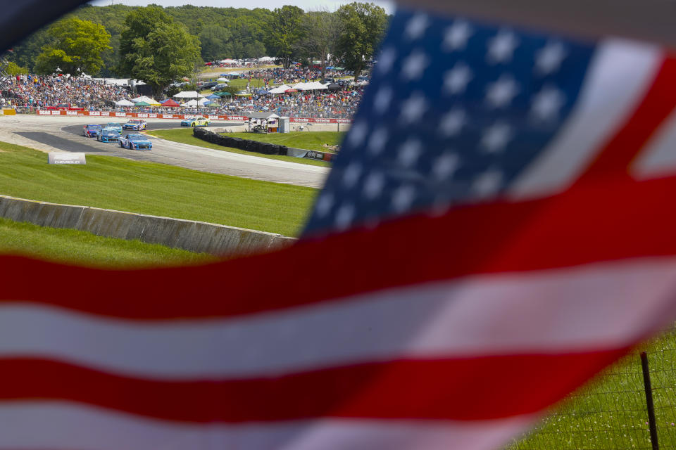 Cars make a turn during a NASCAR Cup Series auto race Sunday, July 4, 2021, at Road America in Elkhart Lake, Wis. (AP Photo/Jeffrey Phelps)