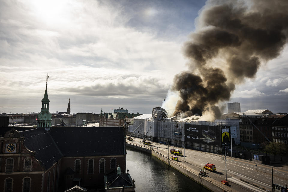 Firefighters work at the scene as smoke rises from the Stock Exchange in Copenhagen, Denmark, Tuesday, April 16, 2024. A fire raged through one of Copenhagen’s oldest buildings on Tuesday, causing the collapse of the iconic spire of the 17th-century Old Stock Exchange as passersby rushed to help emergency services save priceless paintings and other valuables. (Emil Nicolai Helms/Ritzau Scanpix via AP)