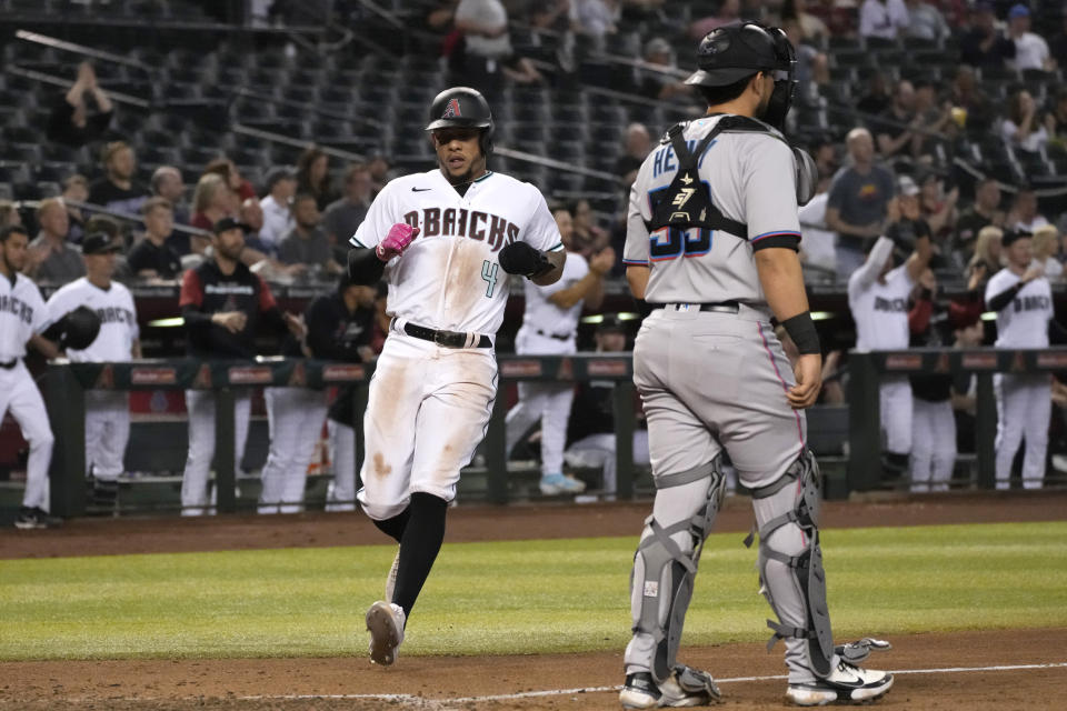 Arizona Diamondbacks Ketel Marte (4) scores a run on a single hit by Nick Ahmed in the third inning during a baseball game against the Miami Marlins, Tuesday, May 10, 2022, in Phoenix. (AP Photo/Rick Scuteri)