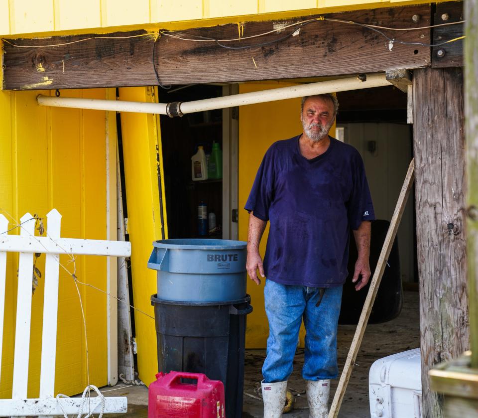 Third-generation oyster farmer Jules Melancon stands in the garage area of his home on Grand Isle, Louisiana, following the passage of Hurricane Ida.