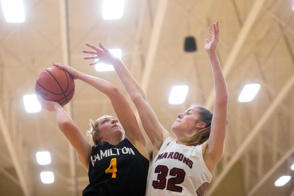 Hamilton's Kaitlyn Geurink takes a shot over Holland Christian's Jenna VandenBrink Tuesday, Jan. 10, 2023, at Holland Christian. 