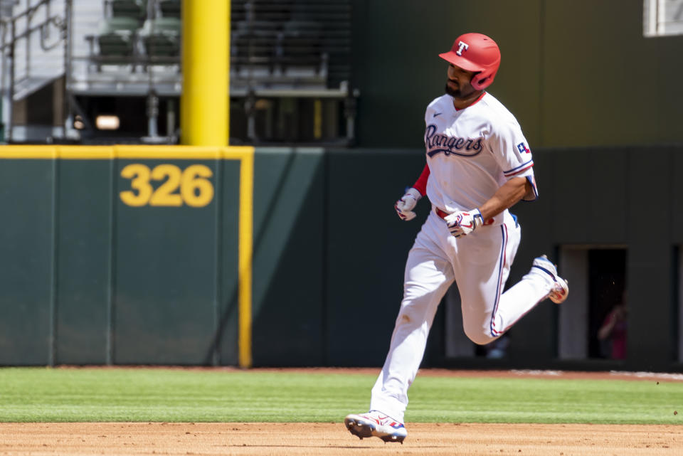 Texas Rangers' Marcus Semien (2) runs the bases after hitting a solo home run in the first inning of a baseball game against the Philadelphia Phillies in Arlington, Texas, Saturday, April 1, 2023. (AP Photo/Emil T. Lippe)