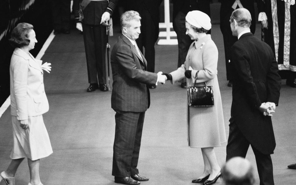 Nicolae and Elena Ceausescu are welcomed at Victoria Station by the Queen and Prince Philip in 1978 - Mirrorpix