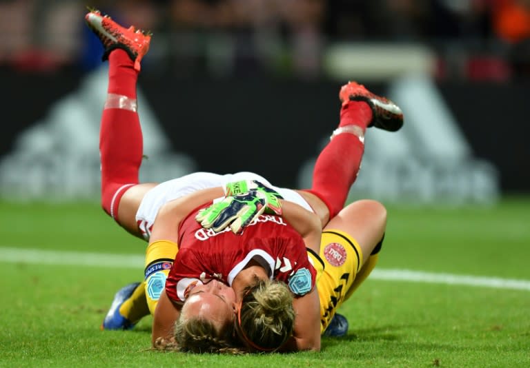 Denmark's goalkeeper Stina Lykke Petersen (down) and Sanne Troelsgaard celebrate on July 24, 2017