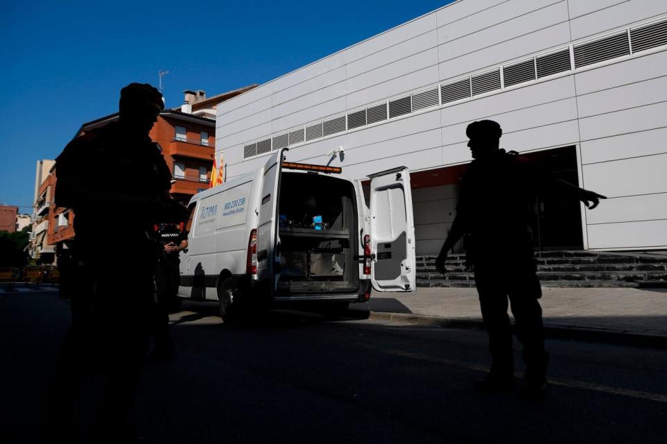 Officers secure the area outside the police station (AFP/Getty Images)