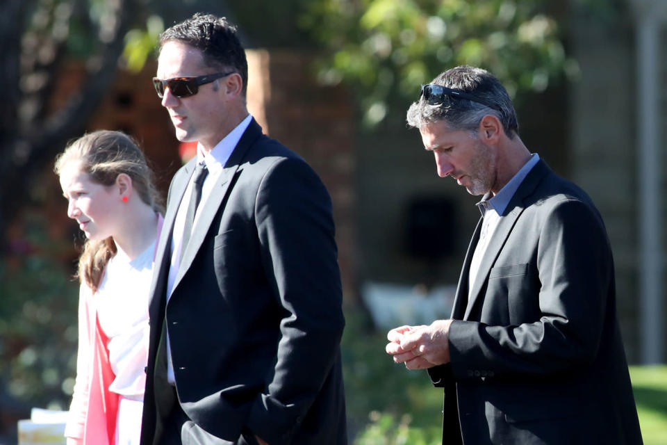 <span>Aaron Cockman (right) leaves Bunbury Crematorium with family and friends after the funerals. Photo: </span>AAP