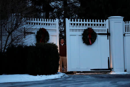A man is seen at the gate to the home of former U.S. President Bill Clinton and former Democratic presidential candidate Hillary Clinton after firefighters were called to put out a fire at the property in Chappaqua, New York, U.S., January 3, 2018. REUTERS/Mike Segar