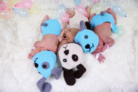 Newborn babies wearing dog costumes to celebrate the New Year of the Dog are pictured at the nursery room of Paolo Chokchai 4 Hospital in Bangkok, Thailand, December 28, 2017. REUTERS/Athit Perawongmetha